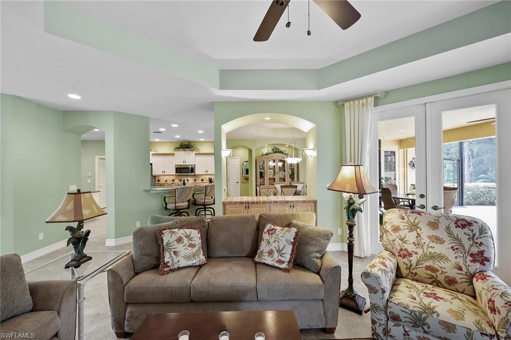 8862 Lely Island Circle Naples, FL 34113 - Photo 10 of 47 a living room with furniture and a large window