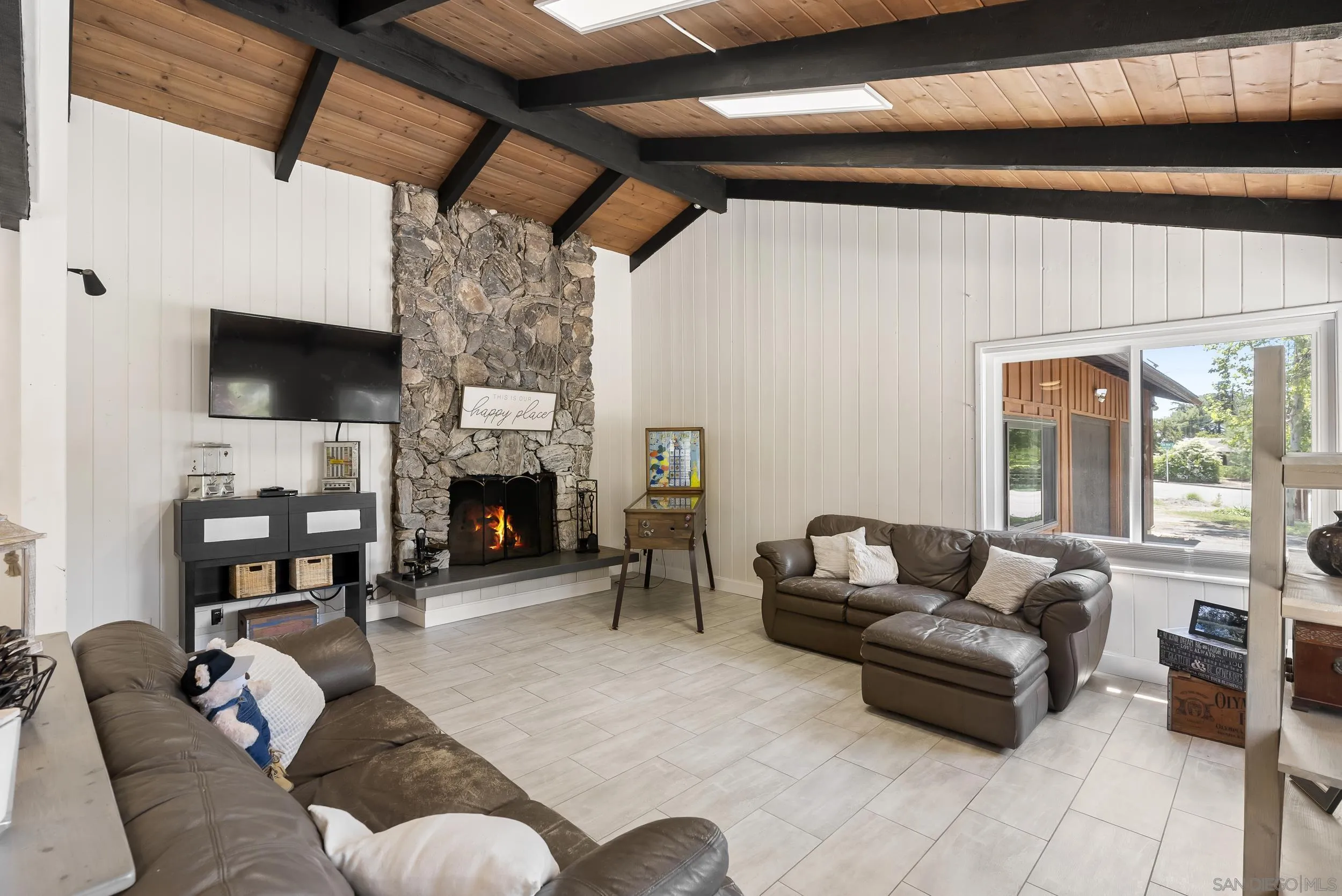 2824 Scenic View Road Alpine, CA 91901 - Photo 8 of 42 a living room with furniture a flat screen tv and a fireplace