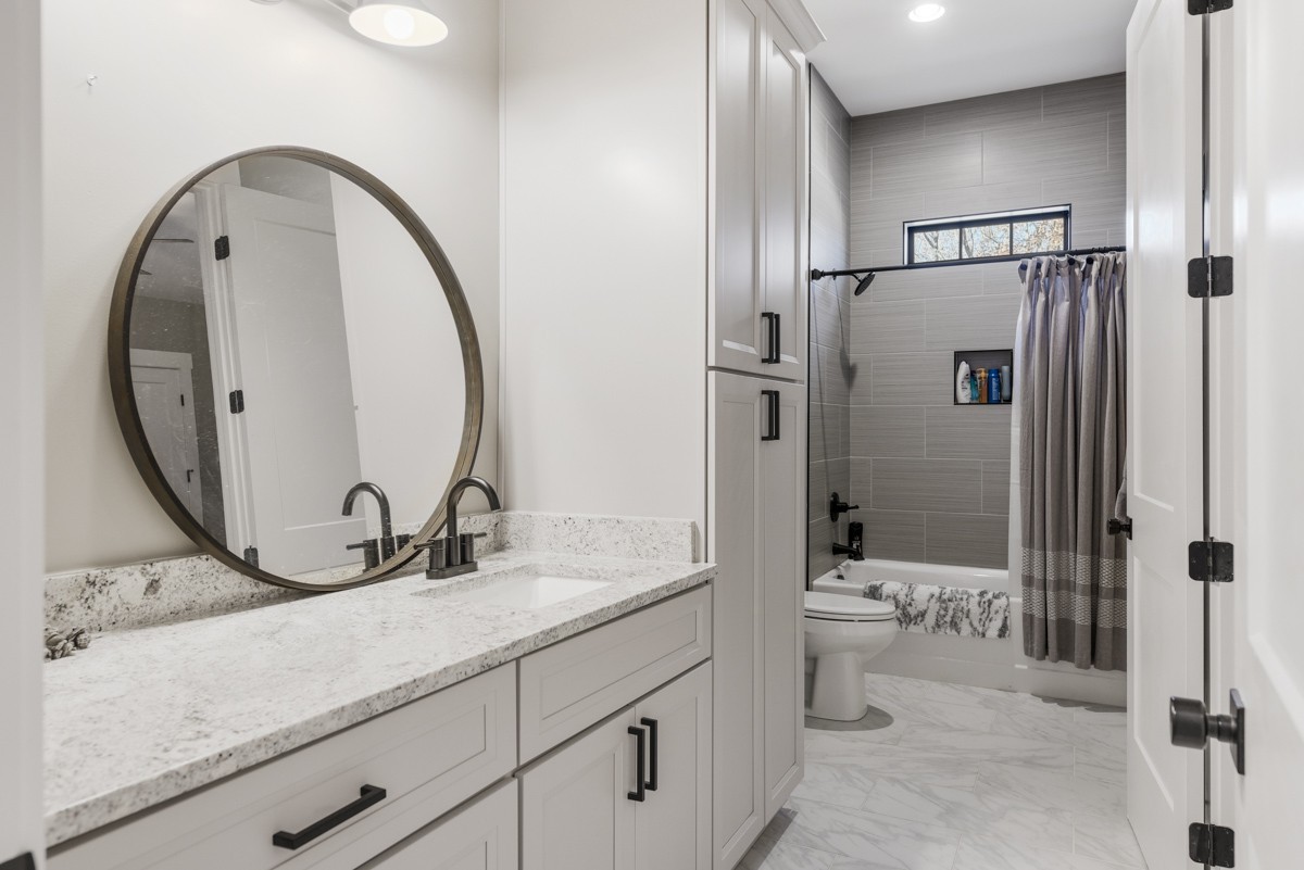 451 Keytown Road Portland, TN 37148 - Photo 48 of 70 a bathroom with a granite countertop sink a toilet and a mirror