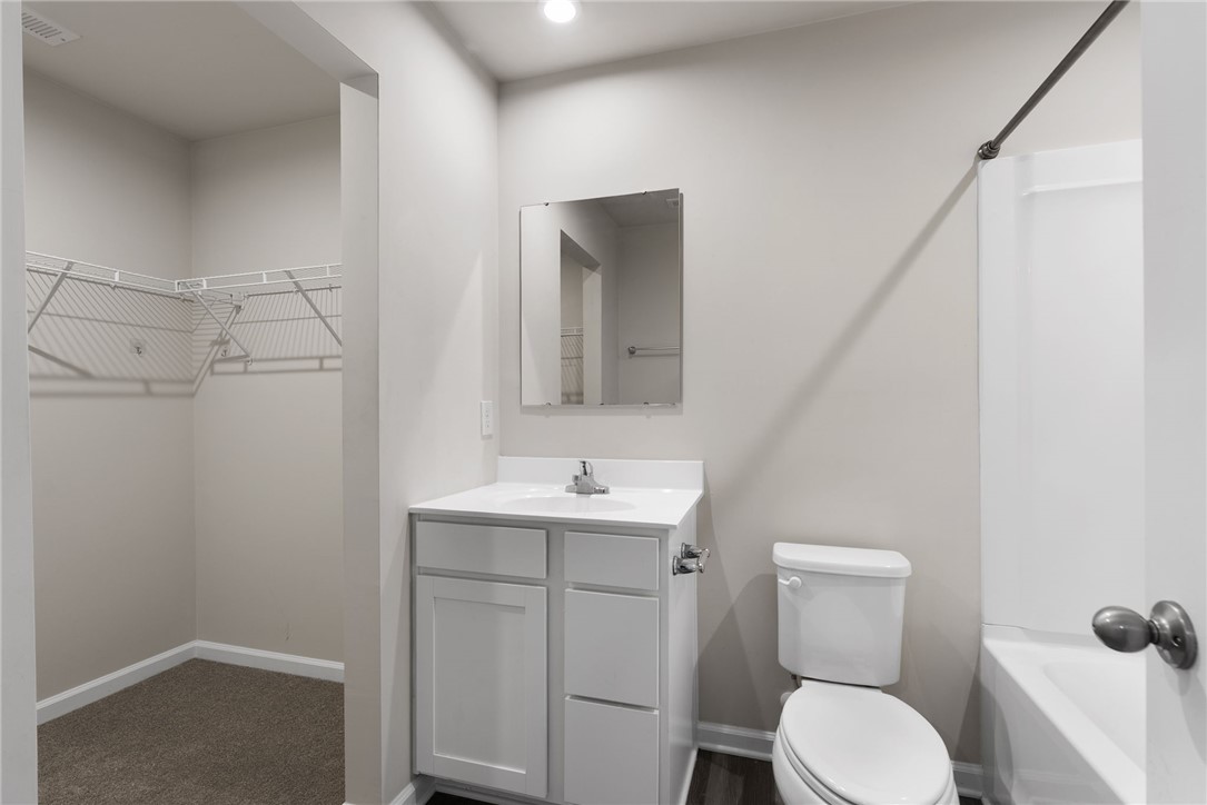 109 Brooklane Court Easley, SC 29642 - Photo 19 of 47 This clean and functional bathroom features a single vanity, a toilet, and an adjacent walk-in closet.
