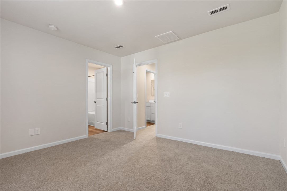 109 Brooklane Court Easley, SC 29642 - Photo 22 of 47 This spacious bedroom offers comfortable carpeting and convenient access to an adjoining bathroom.
