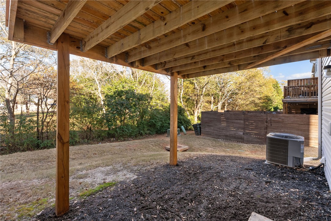 109 Brooklane Court Easley, SC 29642 - Photo 33 of 47 This covered patio offers a tranquil outdoor escape with a clear view of the surrounding greenery.