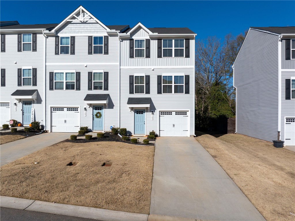 109 Brooklane Court Easley, SC 29642 - Photo 42 of 47 This modern townhome features a light exterior, attached garage, and a welcoming front entrance.