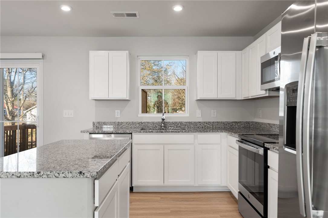 109 Brooklane Court Easley, SC 29642 - Photo 6 of 47 This modern kitchen features ample cabinetry, granite countertops, and stainless steel appliances.
