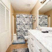7998 East County Highway 30A, Unit 7 Inlet Beach, FL 32461 - Photo 14 of 16 a bathroom with a granite countertop sink a toilet a mirror and shower