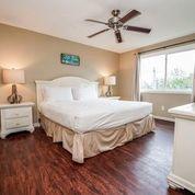 7998 East County Highway 30A, Unit 7 Inlet Beach, FL 32461 - Photo 15 of 16 a bedroom with a bed and a large window with wooden floor