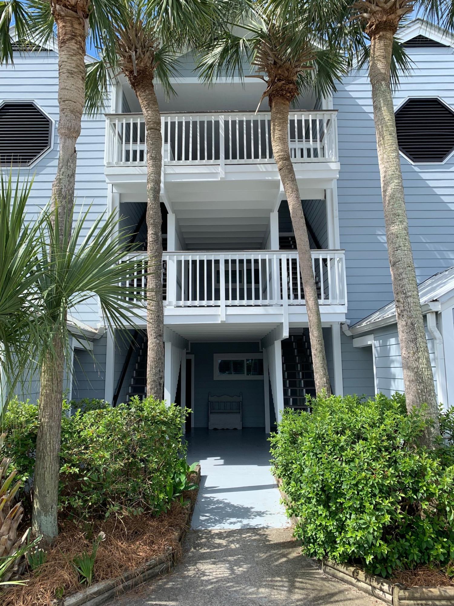 7998 East County Highway 30A, Unit 7 Inlet Beach, FL 32461 - Photo 2 of 16 a view of a brick house with large windows and a small yard