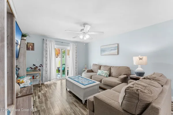 a living room with furniture and wooden floor