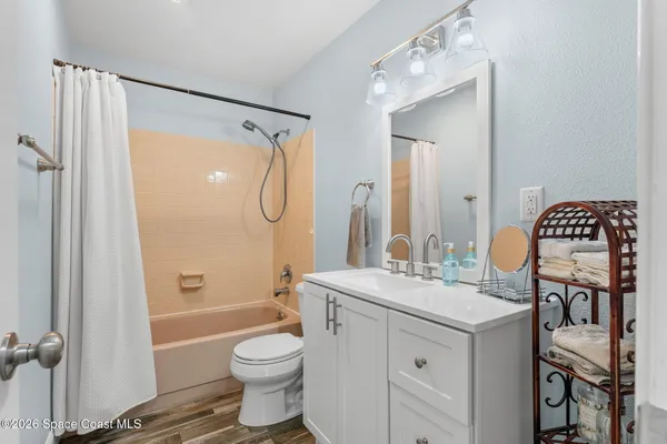 a bathroom with a sink toilet tub and shower