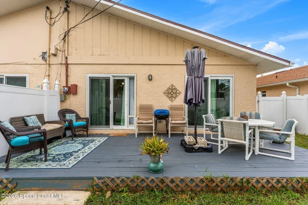 a view of a patio with table and chairs potted plants