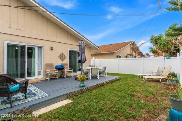 a view of a backyard with chairs and a table