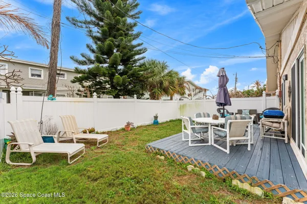 a view of a chairs and table in patio