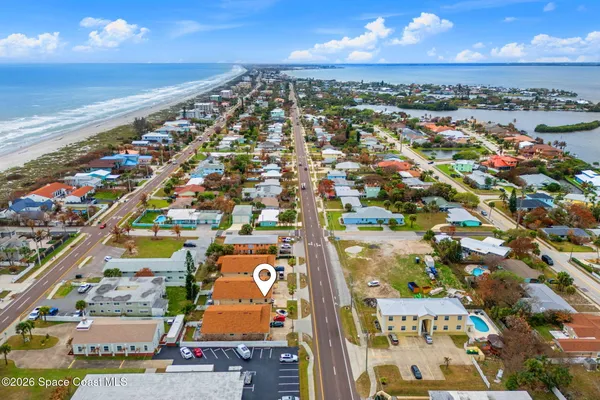 an aerial view of residential building and ocean