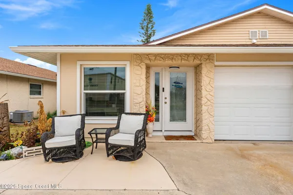 a view of backyard with outdoor seating space