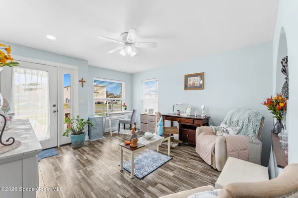 a living room with furniture and wooden floor