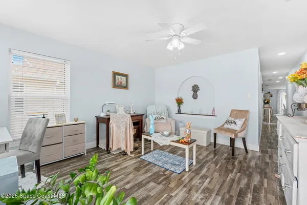 a living room with furniture and wooden floor