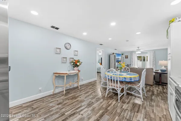 a view of a dining room with furniture and wooden floor