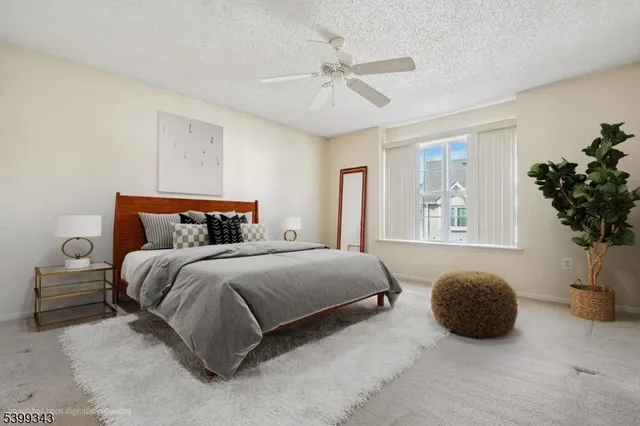 a bedroom with a bed and a potted plant