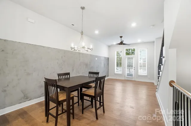 a view of a dining room with furniture and a chandelier