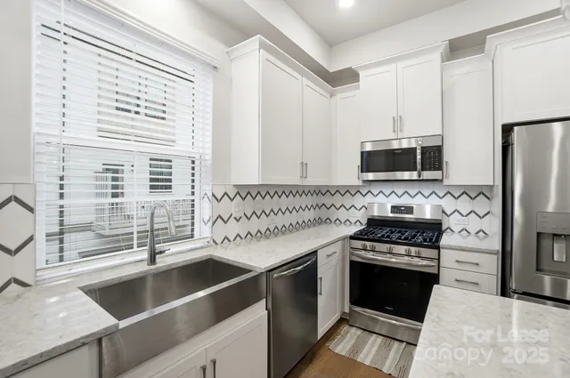 a view of a livingroom with furniture and a chandelier