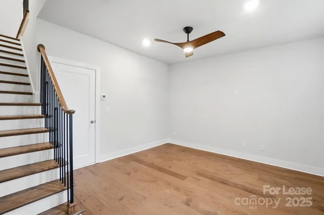 a view of a room with wooden floor and white walls