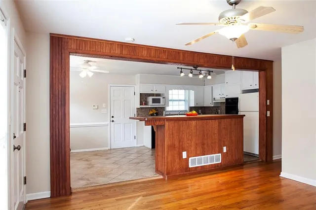 a view of kitchen with stainless steel appliances granite countertop room