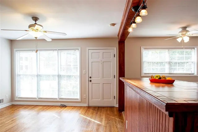 a kitchen with stainless steel appliances cabinets and a large window