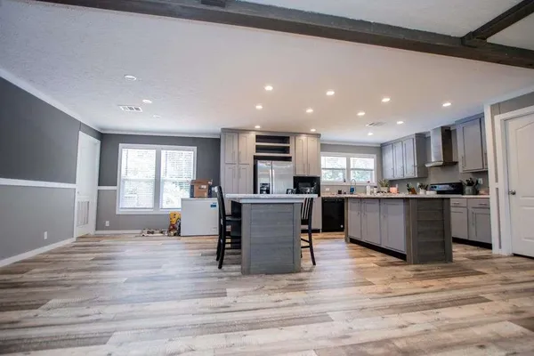 a kitchen with a refrigerator a sink and cabinets