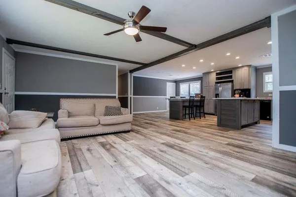 a kitchen with stainless steel appliances a refrigerator sink and microwave
