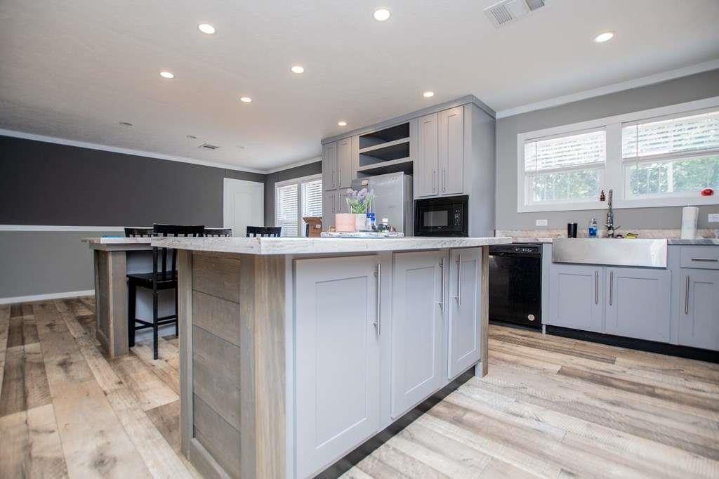 200 Duck Pond Road Roopville, GA 30170 - Photo 23 of 89 a kitchen with stainless steel appliances granite countertop a stove top oven a sink dishwasher and a refrigerator with wooden floor