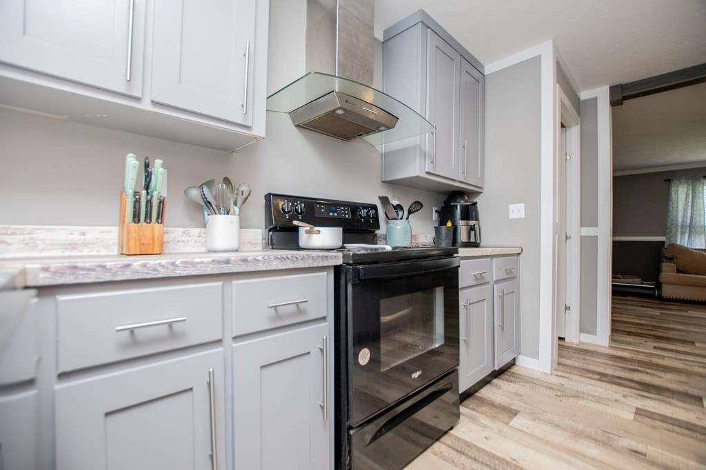 200 Duck Pond Road Roopville, GA 30170 - Photo 31 of 89 a kitchen with stainless steel appliances granite countertop a stove and cabinets