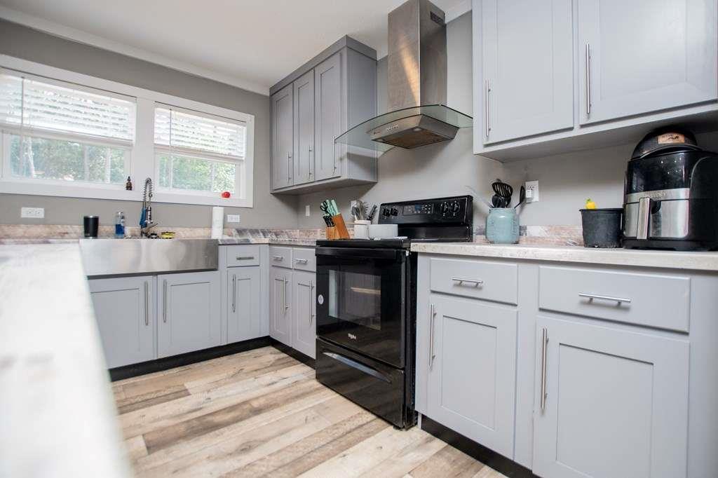200 Duck Pond Road Roopville, GA 30170 - Photo 33 of 89 a kitchen with stainless steel appliances granite countertop a sink a stove and cabinets
