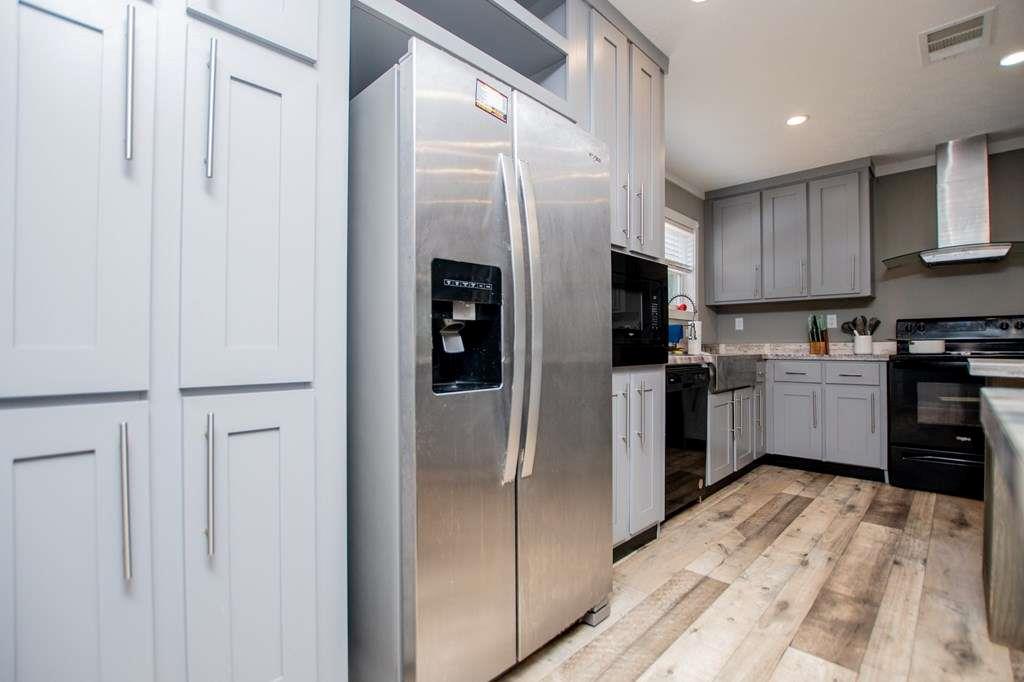 200 Duck Pond Road Roopville, GA 30170 - Photo 34 of 89 a kitchen with a refrigerator a sink and cabinets