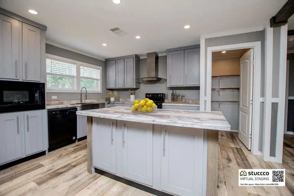 a kitchen with stainless steel appliances granite countertop a sink a stove a refrigerator and cabinets