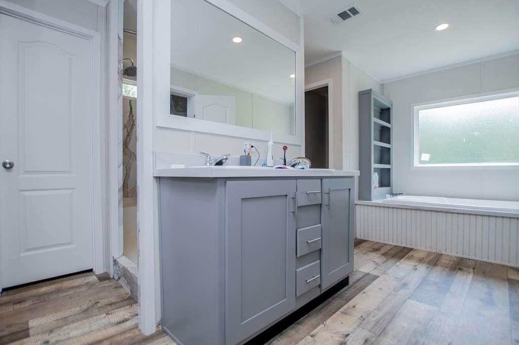 200 Duck Pond Road Roopville, GA 30170 - Photo 51 of 89 a bathroom with a granite countertop sink mirror and bathtub