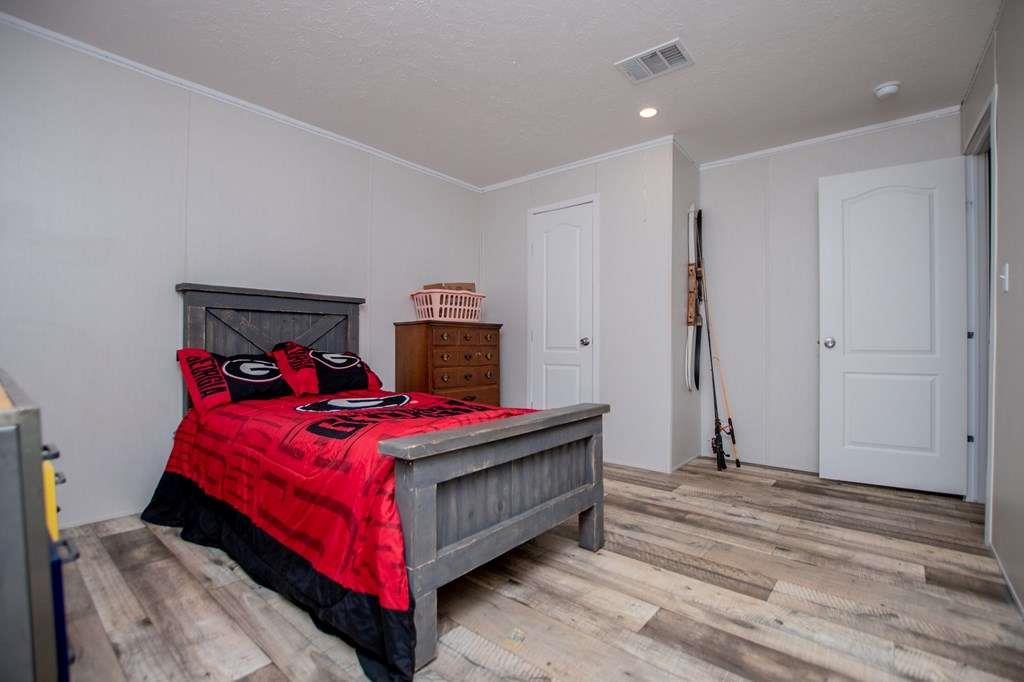 200 Duck Pond Road Roopville, GA 30170 - Photo 55 of 89 a bedroom with a bed and a table