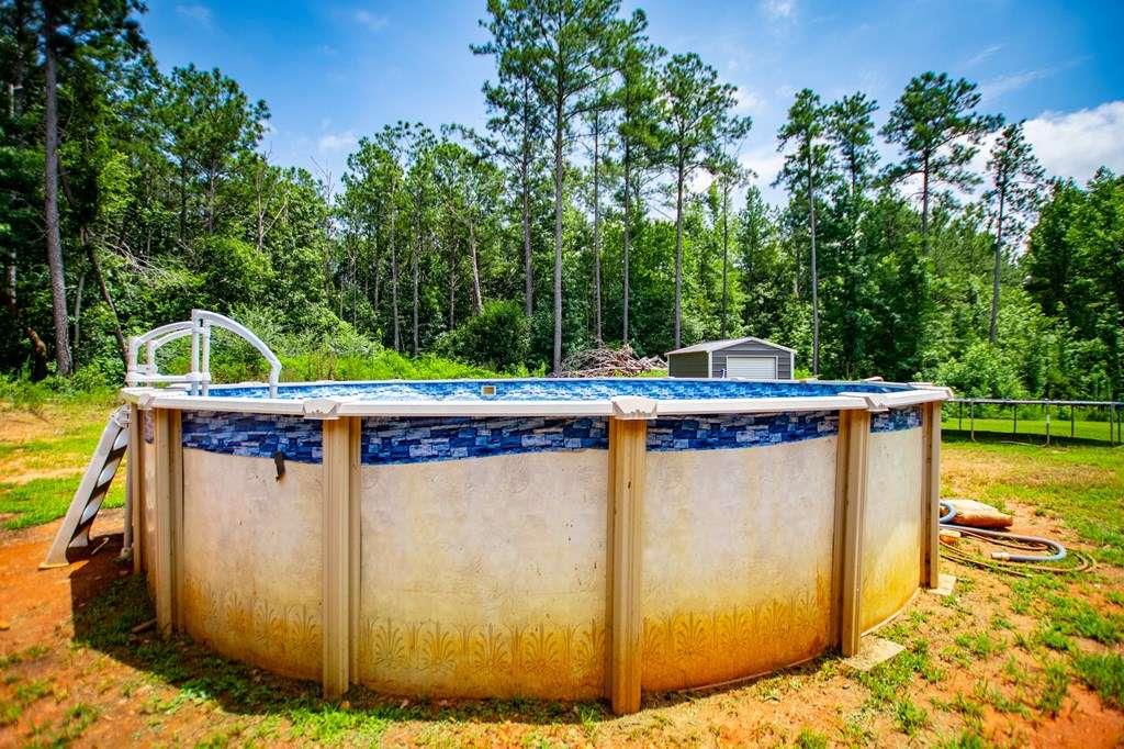 200 Duck Pond Road Roopville, GA 30170 - Photo 77 of 89 a view of a swimming pool with a porch