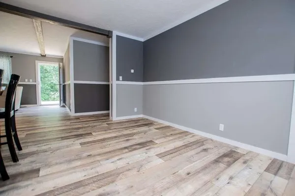 a view of a house with a yard and trees