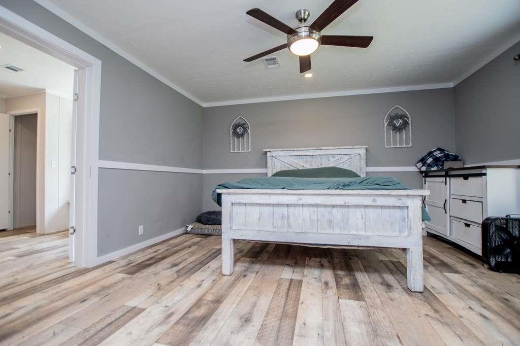 200 Duck Pond Road Roopville, GA 30170 - Photo 10 of 89 a bedroom with a bed and a chandelier