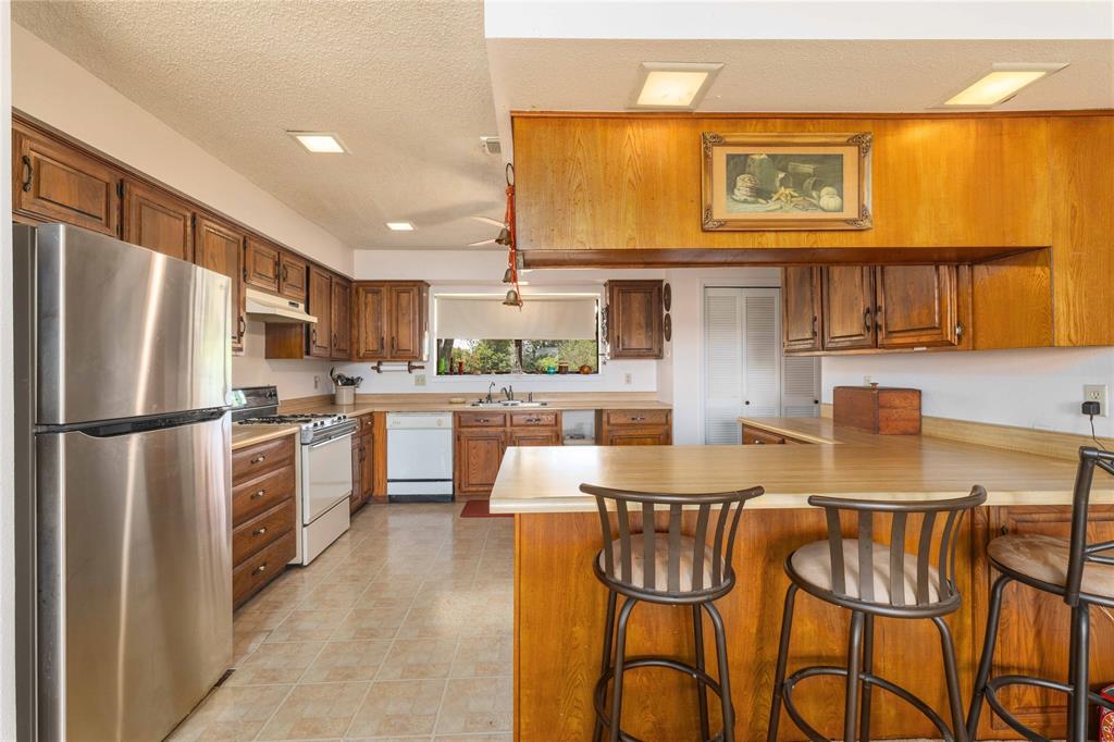 3718 Highway 36 Rising Star, TX 76471 - Photo 21 of 36 a kitchen with stainless steel appliances a refrigerator and a stove top oven