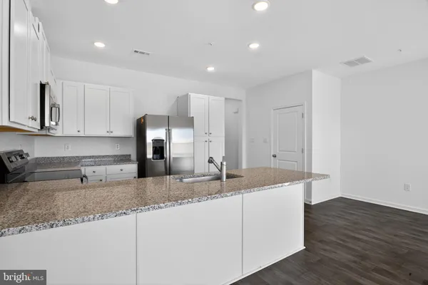 a kitchen with stainless steel appliances granite countertop a sink and a granite counter tops