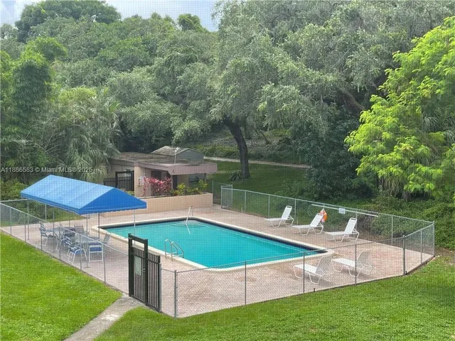 swimming pool view with a seating space