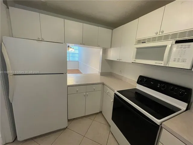 a kitchen with cabinets and a stove