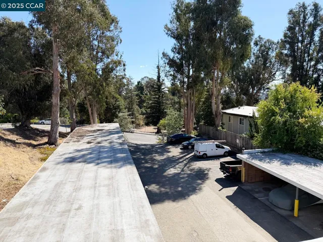 a view of a kitchen with wooden floor and a ceiling fan