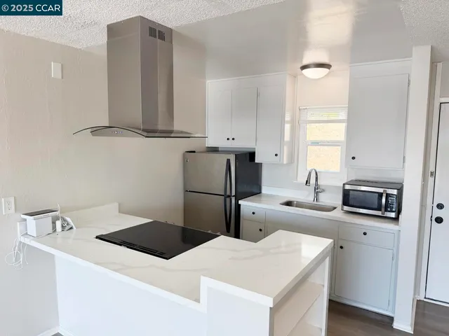 a kitchen that has a sink and a stove in it