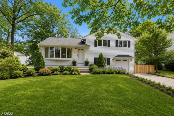 a view of a house with backyard sitting area and garden