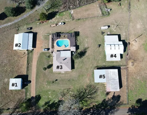 an aerial view of residential house with outdoor space and parking