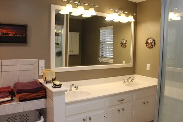 a bathroom with a sink double vanity and a mirror