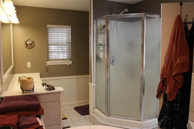 a bathroom with a tub and shower