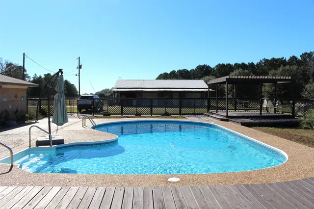swimming pool view with a outdoor seating